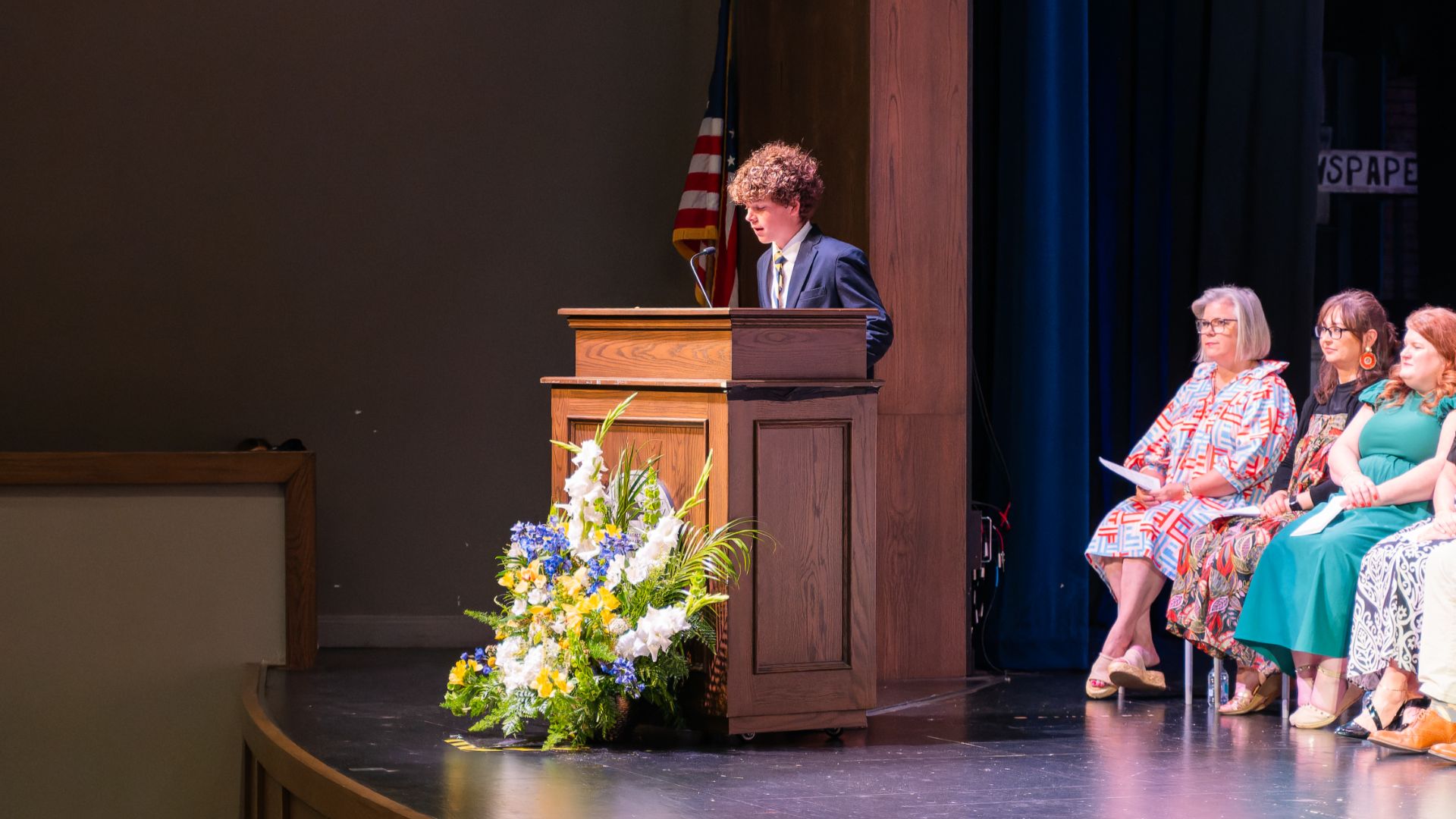 photo of student talking on stage